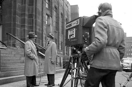 Television reporter prepares a broadcast in front of the courthouse during the Sheppard trial, 1954.