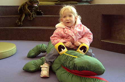 Young patron with a stuffed animal in children's area, 2001